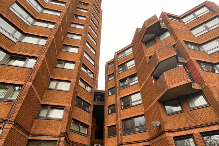 red brick tower blocks with black windows