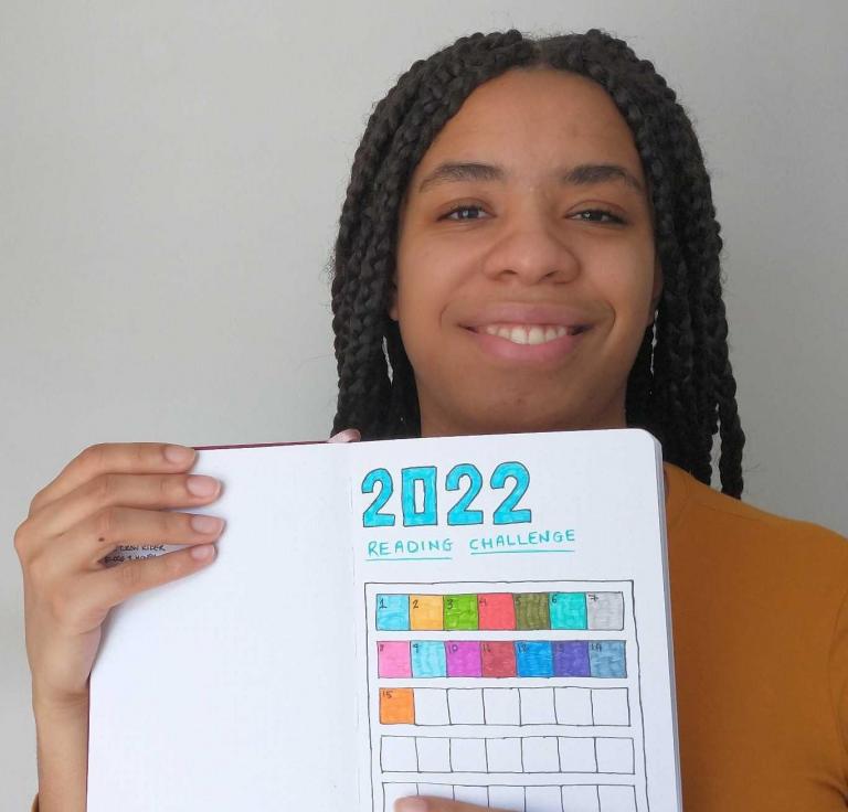 Keira holds up her book journal