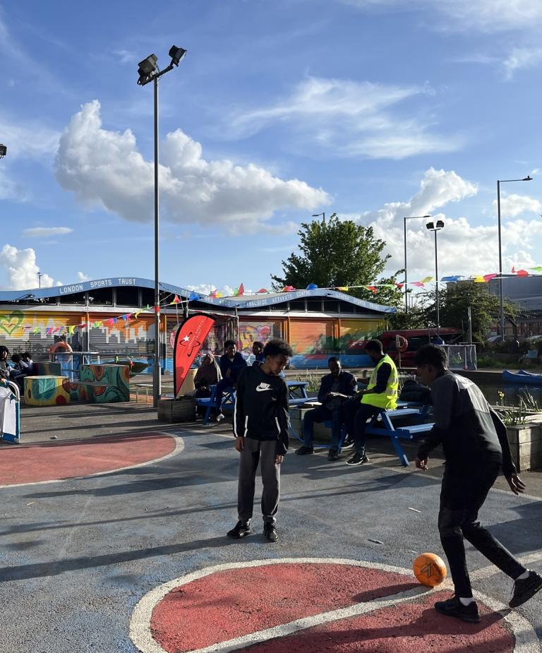 Young people play ball games outside in the sun