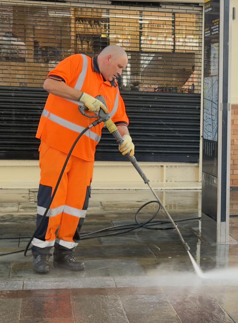 A Suez worker clears up during Carnival 2026