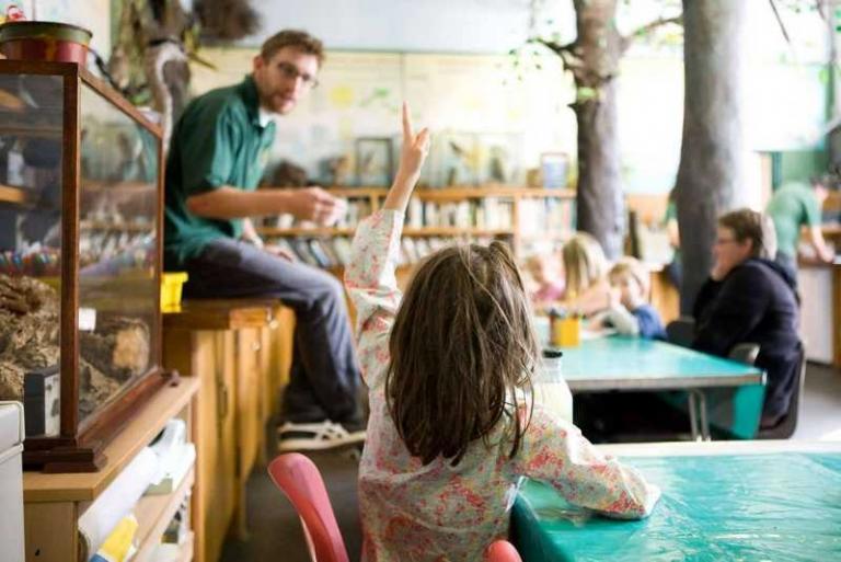 Picture of a classom in the Ecology centre with children answering questions from the teacher.