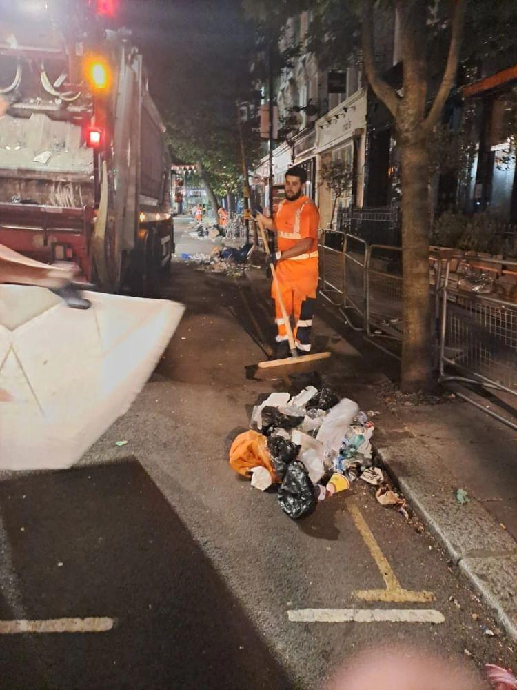 A Suez worker clears up during Carnival 2025