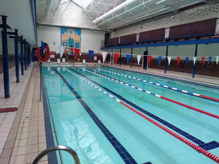 A photograph of an indoor swimming pool