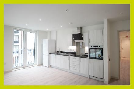 A white kitchen with full length glass doors
