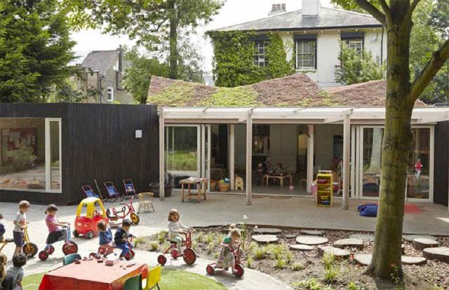 Outside shot of the Montpelier Nursery showing a playground and children playing