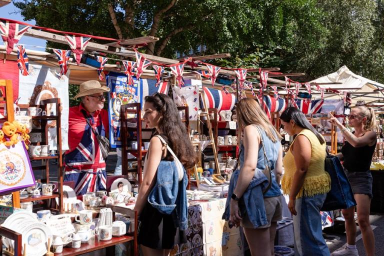 Shoppers browse a stall at portobello market