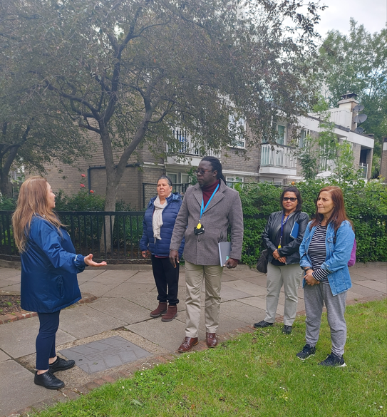 Project manager, resident liaison officer and residents walking around the Silchester Estate discussing the proposed work