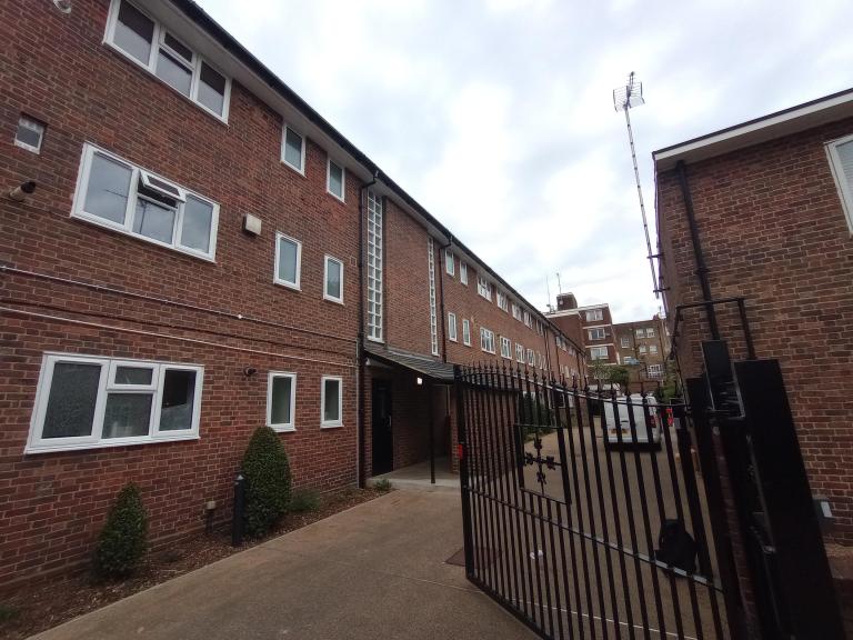 image of The Sandhills building - red brick and new white double glazed windows