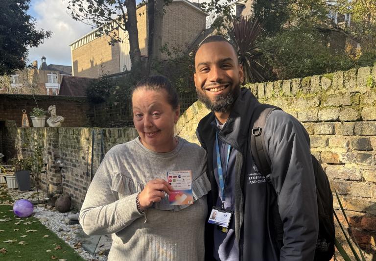 Competition winner, Tracey, shows off her voucher, accompanied by Aaron, the visiting officer