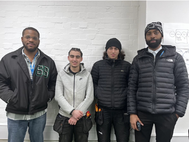 4 men standing next to eachother 