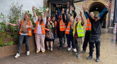 Nine residents and council staff celebrating their project outside of Latimer Road Underground station