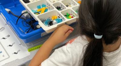 A young girl playing with Lego