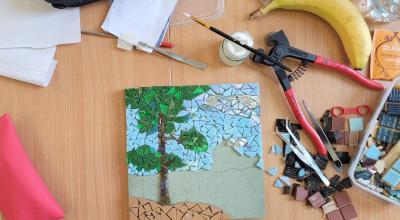 A mosaic tile picture being put together on a desk.