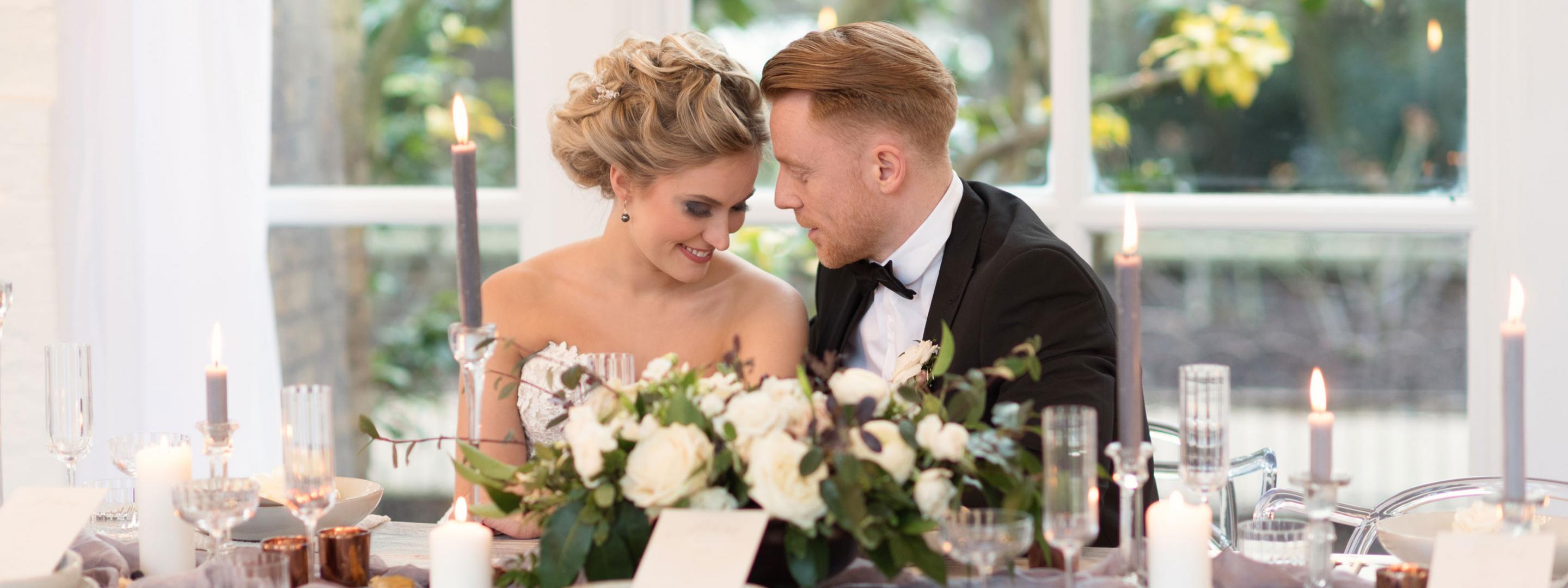couple sitting at table at wedding