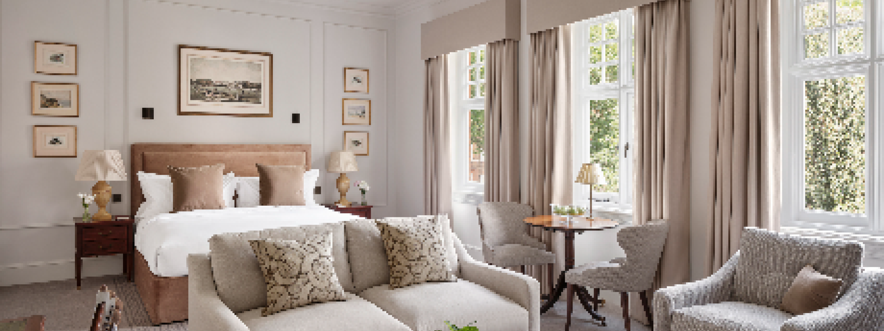 Chelsea Town House, King size Room showing arrangement of bed and living area containing two sofas and a coffee table