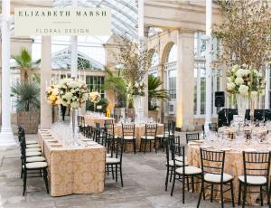 Decorated room with chairs and tables laid out for celebration.