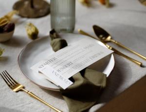 Place setting and plate with a menu card resting on the place