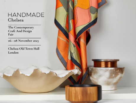 Promotional image for Handmade Chelsea: The Contemporary Craft and Design Fair, showing a display of artisan objects including a sculpted ceramic bowl, a polished wooden vessel, a marbled pot with copper coil, and a colourful patterned fabric draped above. 