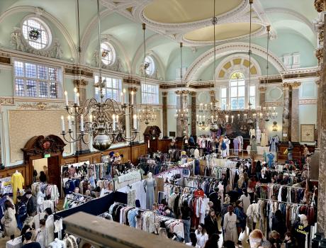 A huge crowd gathers in a hall adorned with different frocks, dresses and gowns